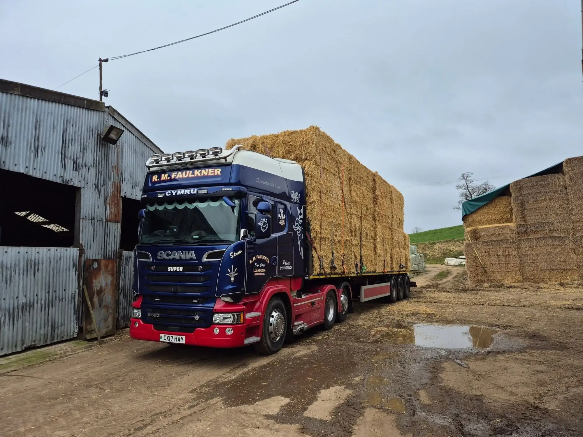 Scania R520 CX17 HAY loaded with straw outside the farm barns