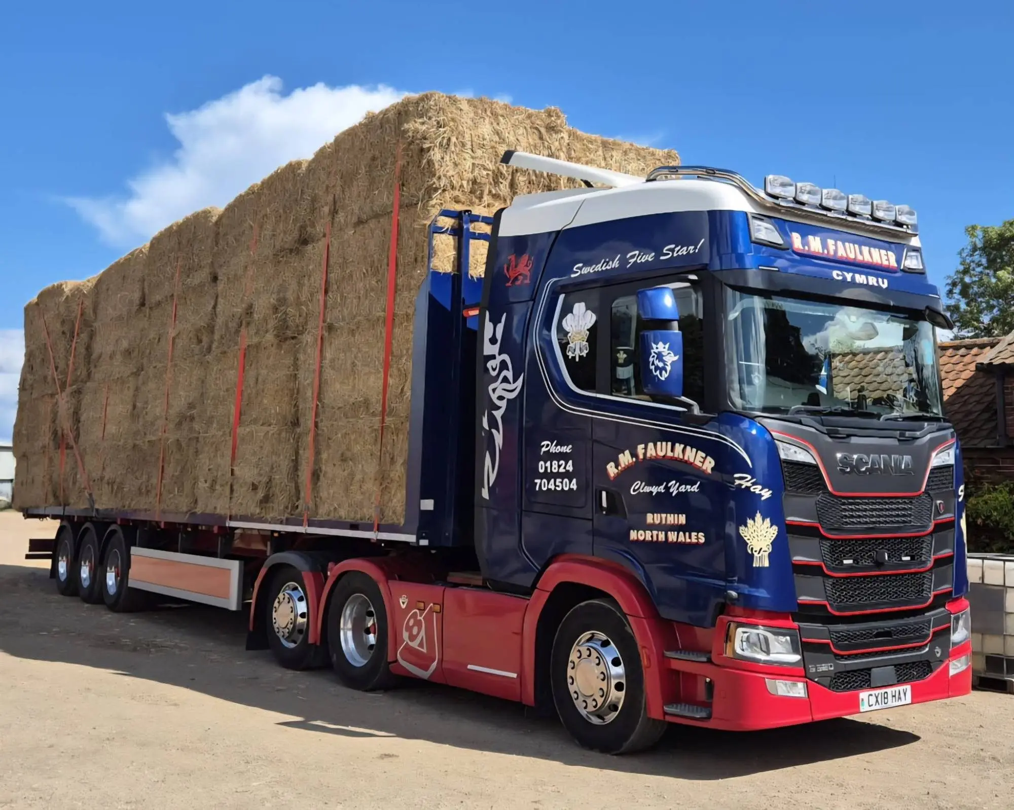 Scania CX18 HAY in R M Faulkner navy and red, loaded with straw bales under a blue sky