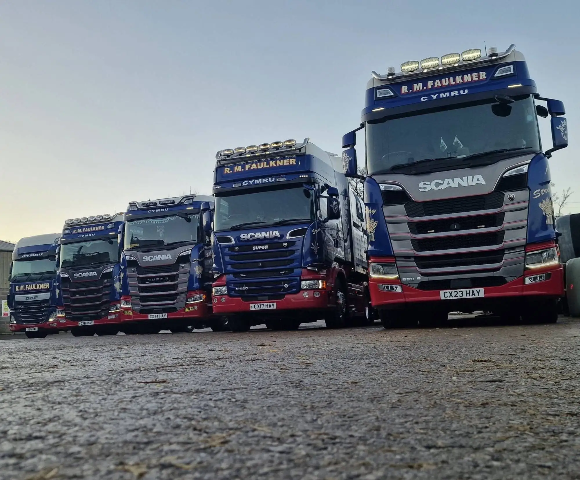 R M Faulkner lorries lined up at the yard at dusk